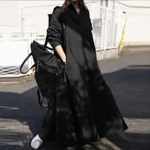 Full length view of black loose long-sleeved oversized maxi dress with large hem