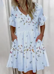 Detail of white V-neck dress featuring colorful butterfly print and side pockets