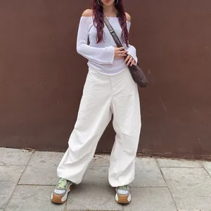 Fashionable white wide-leg cargo pants for women featuring a functional drawstring hem