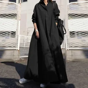 Close-up detail of loose black cotton linen long-sleeved maxi dress with big swing
