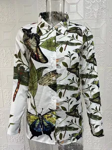 Detail shot of women's long-sleeve shirt with vintage dragonfly and butterfly print