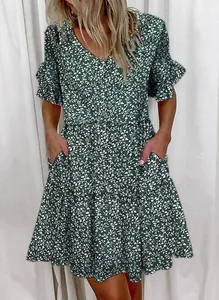 Close-up detail of green floral V-neck summer dress featuring ruffles and pockets.