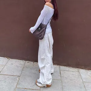 Side view of woman wearing white low-waist wide-leg cargo pants with drawstring