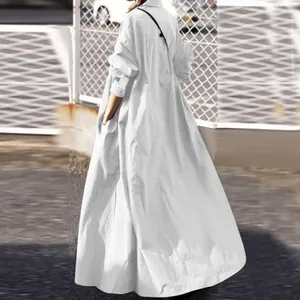 Back view of a long-sleeved white maxi shirt dress featuring a loose-fitting silhouette.