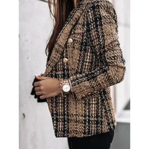 Détail d'un blazer classique en tweed marron à double boutonnage avec des boutons dorés