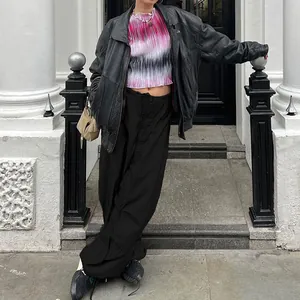 Street style detail of black wide-leg cargo pants with adjustable drawstring waist