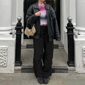 Full outfit view of black Y2K drawstring cargo pants styled with an oversized leather jacket