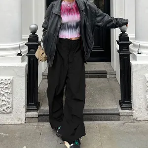 Street style view of low-rise wide-leg cargo pants with adjustable drawstring waist.