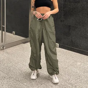 Detailed view of women's olive green wide leg cargo pants featuring drawstring waist