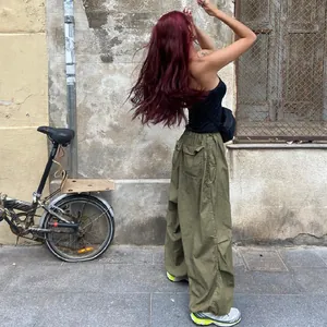 Back view of stylish olive green baggy cargo pants with low waist streetwear vibe