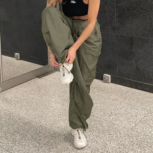 Detailed view of olive green low-waist drawstring cargo pants with wide-leg fit