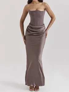 Elegant strapless corset-style evening gown with draped skirt and floor length.