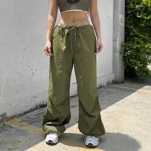 Detailed view of trendy olive green low-rise wide-leg cargo pants with drawstring waist