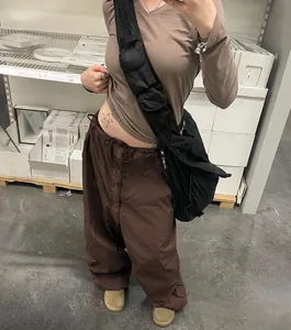 Detail view of brown low-waist wide-leg cargo pants with adjustable drawstring waist