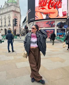 Fashionable brown wide-leg cargo pants with drawstring waist in urban street setting