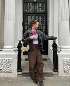 Close-up detail of trendy brown low-waisted baggy cargo pants with elastic drawstring waist