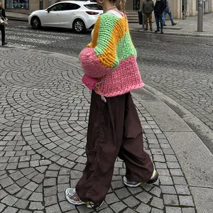 Detail view of brown low-waist wide-leg cargo pants with drawstring on street