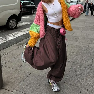 Street style close-up view of brown low waist wide leg cargo pants with functional drawstring waist.