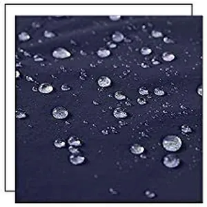 Close-up detail of waterproof fabric with water droplets on navy blue men's beach shorts.