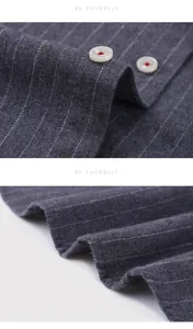 Close-up detail of premium grey striped fabric and buttons on men's fleece-lined warm shirt