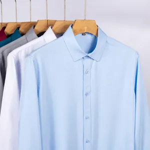 A collection of professional men's long-sleeve business shirts in multiple colors on hangers.
