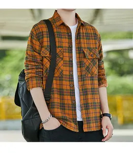 Detailed macro view of men's orange plaid flannel shirt with thick lamb wool lining