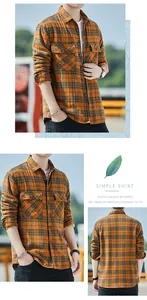 Detail view of men's warm orange plaid flannel shirt with double chest pockets