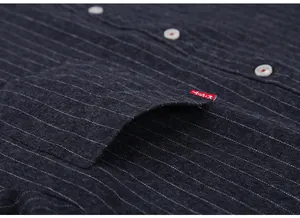 Close-up detail of a men's thick grey striped shirt showing pocket and buttons