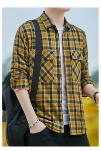 Close-up of a men's yellow and black plaid warm flannel shirt with front pockets