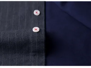 Close-up of men's grey pinstripe fleece-lined shirt with white button detail