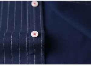 Macro view of navy striped warm shirt showing fabric texture and button detail