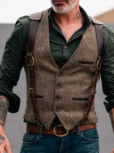 Detail view of vintage tweed men's vest with leather harness straps and rustic buttons