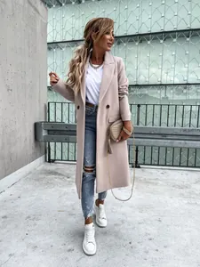 Elegant slim-fit pink wool coat with notched lapel shown in a stylish outdoor setting