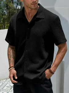 Macro view of black men's short sleeve casual shirt showing textured waffle fabric