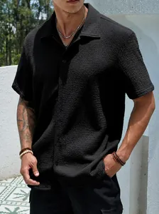 Macro view of black men's short sleeve casual shirt showing textured waffle fabric