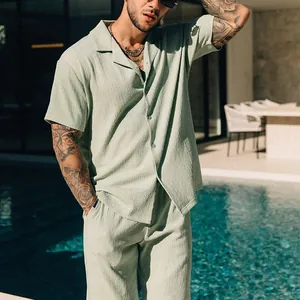 Detail shot of men's sage green textured casual summer short sleeve shirt and shorts set.