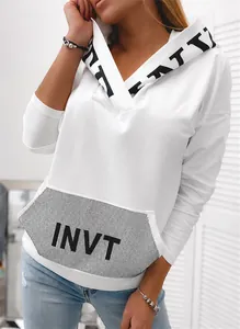 Close-up detail of white women's hoodie featuring a sequined INVT letter print pocket design