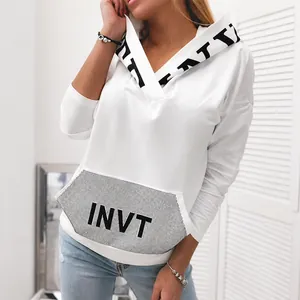 Women's oversized white hoodie featuring bold letter print and unique rhinestone pocket detail