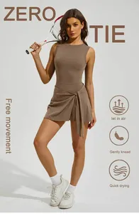 Detailed view of brown one-piece tennis dress with cross tie-waist and breathable fabric