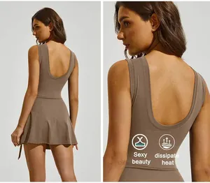 Close-up back detail of brown athletic tennis dress with U-back and criss-cross hem