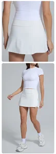 Detailed view of white high-waisted athletic tennis skort showing fit and fabric texture