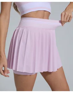 Close-up of pink high-waisted pleated tennis skort showing waistband elasticity.