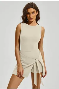 Detail view of the wrap-tie waist on a breathable beige one-piece tennis sports skort