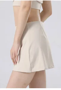 Side view detail showing the fit and fabric of a high-waisted beige quick-dry yoga tennis skirt