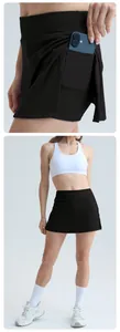 Detail shot of black sports tennis skirt featuring a convenient side phone pocket.