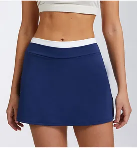 Close-up detail view of high-waist navy blue tennis skirt with white ribbed waistband