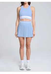 High-waisted light blue pleated tennis skirt and matching racerback crop top sports set