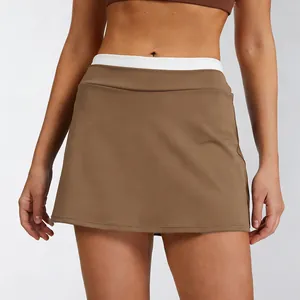 Detail view of high waist brown athletic tennis skort with white ribbed waistband
