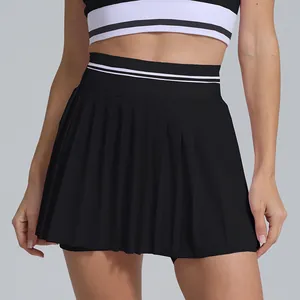Close-up detail showing the high-waist pleated black tennis skirt with sport stripes.
