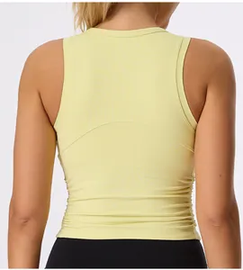 Close-up back view of yellow slim-fit yoga vest featuring pleated side details